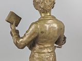 statue of a boy with a book in his hands