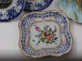 a plate with a flower on it sitting on a table