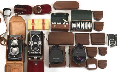 many different types of cameras and accessories laid out on the table