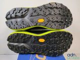 the soles of a pair of running shoes on top of a blue mat
