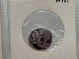 a silver coin in a plastic package on a table