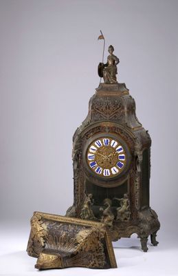 a clock that is sitting on a table next to a box