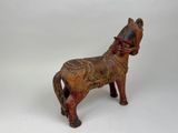 a wooden horse that is standing on a white surface