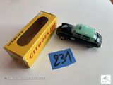 une petite voiture miniature posée à côté d'une boîte sur une table