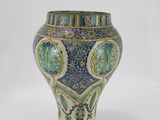 a blue and white vase sitting on a white surface