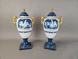 pair of blue and white vases with gold handles and handles