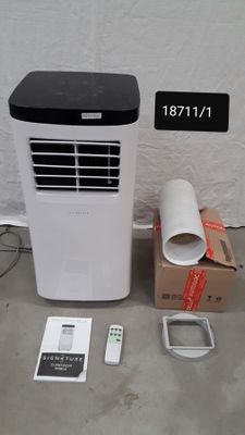 a white and black air conditioner sitting next to a cardboard box