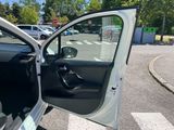 a white car with its door open in a parking lot