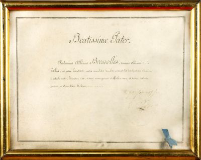 framed photograph of a document with a blue ribbon on it