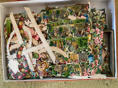 a box with a bunch of paper cutouts in it