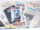 several newspapers are stacked on top of each other on a table