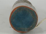 a blue and orange cup sitting on a white surface