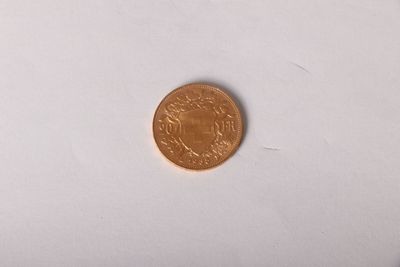 a small coin that is on a white surface