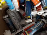 many tubes of paint in a cardboard box