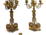 pair of antique brass candelabs with blue and white designs