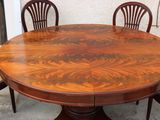 a large wooden table with four chairs around it