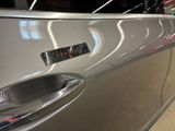 a close up of a car door handle with a sticker on it