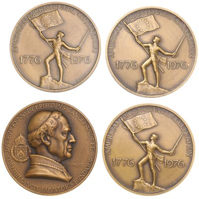 four bronze medals depicting a man holding a flag, a woman holding a flag and a man holding a flag