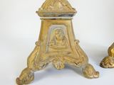 pair of antique brass candlesticks with figures on top of them