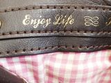 a close up of a leather bag with writing on it