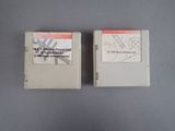 an image of two nintendo game cartridges sitting side by side on a table