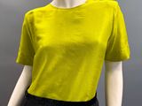 the mannequin is wearing a yellow shirt and black skirt