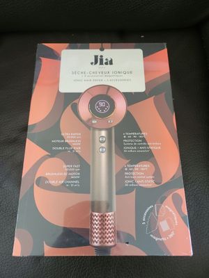 packaging of a hair dryer sitting on top of a black chair