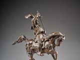 an image of a statue of a man on a horse with a spear