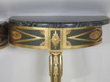 a table with a marble top and gold decorations on it