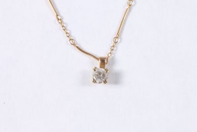 gros plan d'un collier avec un diamant sur une chaîne