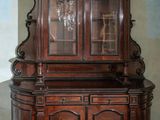 a wooden cabinet with a glass door in a room