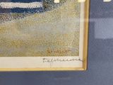 framed painting of a beach scene with a blue and white striped umbrella