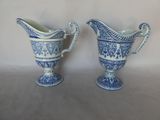 two blue and white vases sitting next to each other