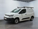 the white van is parked in a large room with a roof rack