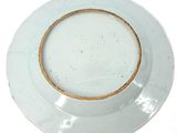 a white plate with a brown rim on a white table