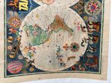 an old map of the world on display in a museum