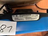 a blue surfboard with a black and white sticker on it