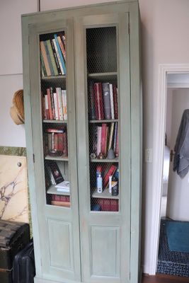 a tall bookcase with a bunch of books in it