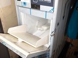a small refrigerator that has a shelf on top of it