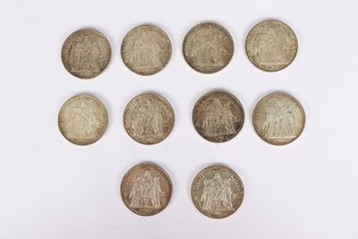 a close up of a bunch of coins sitting on top of a white surface