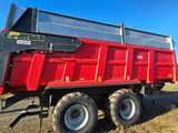 a red dump truck that is parked on the side of the road