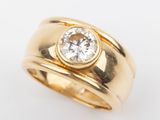 a close up of a gold ring with a diamond in the center