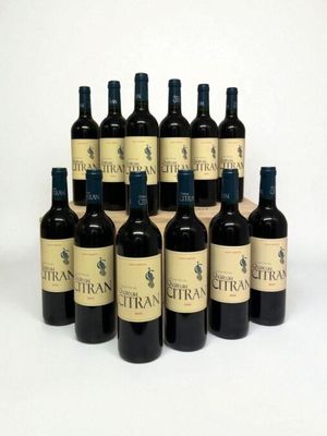 six bottles of wine are lined up in a row on a white surface