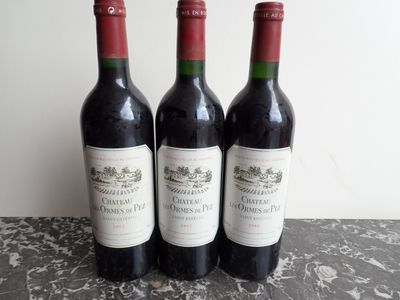 three bottles of wine sitting on top of a table next to each other