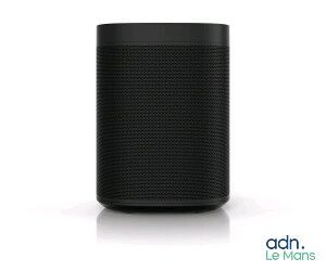 a black speaker sitting on top of a white surface