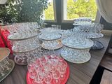 many empty wine glasses sitting on a table in front of a window