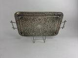 an ornate silver tray with handles and handles on a stand