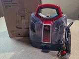 a vacuum that is sitting on the floor next to a box