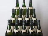a group of bottles of wine sitting on top of a wooden table