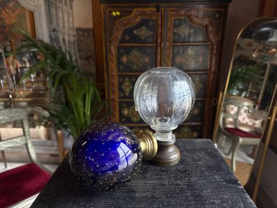 a blue glass ball sitting on top of a black table